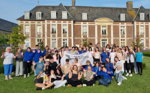 Group photo of Walton Academy Year 8 students and staff standing outside Le Château de Chantereine accommodation during their Normandy Trip 2025.